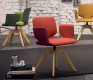 Red, green and yellow examples of the Aye swivel dining chair