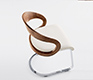 Gorgeous high-angle shot of the solid wood, leather and chrome cantilever Girado dining chair