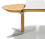 A close-up view of the Girado round dining table as it extends