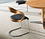 Luxury cantilever dining chair in heart beech, black leather and steel