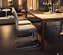 Luxury white leather upholstered Magnum cantilever dining chair shown with a Magnum table