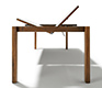 End view of the Magnum dining table in walnut shown with integrated extension mechanism
