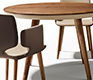 Small high-end luxury dining table showing the superb leather upholstered underbelly and walnut legs and table top