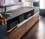High-end Cubus media unit cabinets shown in charcoal black glass and walnut