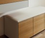 White leather-upholstered hallway storage bench