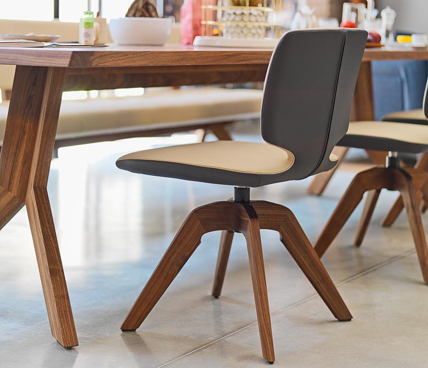 Beautiful luxury two-tone leather dining chair with a swivel wood base