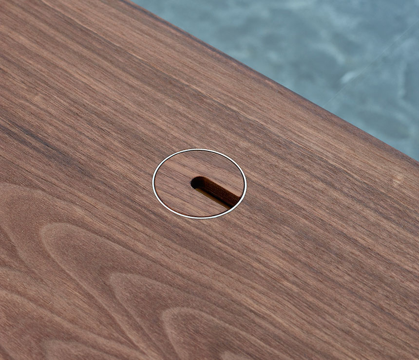 Close-up of the cable access hole on the Danish Modern desk