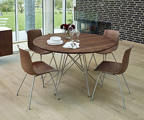 Round Danish Modern table with solid hardwood table top and steel spider-like legs.
