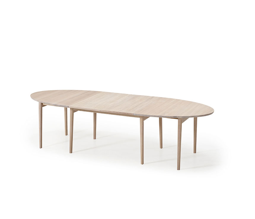 Partially extended ellipse-shape dining table that seats 6 to 14