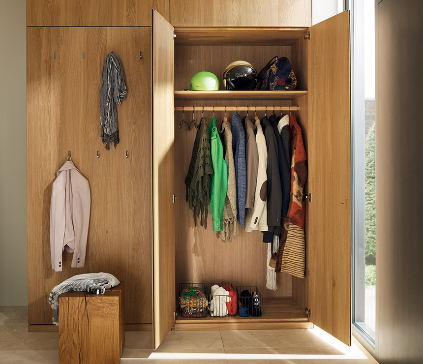 Floor to ceiling hallway cabinets with coat rack