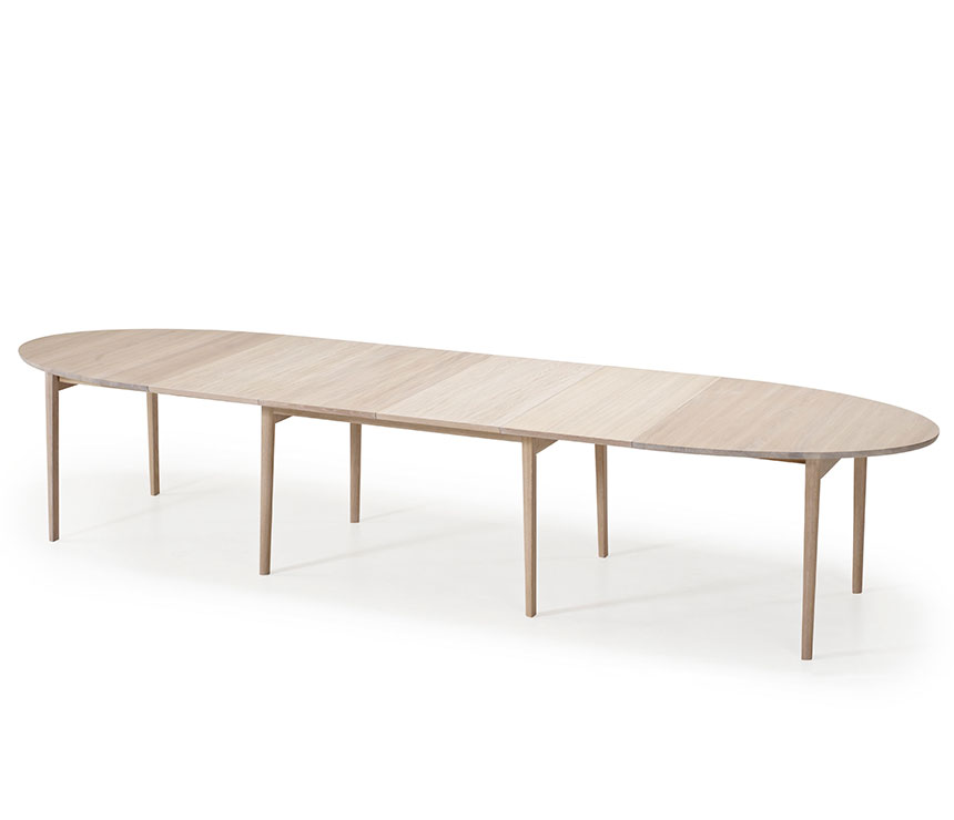Fully-extended ellipse-shaped dining table that seats 6 to 14