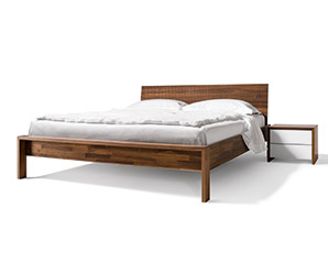 An impressive walnut bed that combines the Relief headboard with the Lunetto bed frame