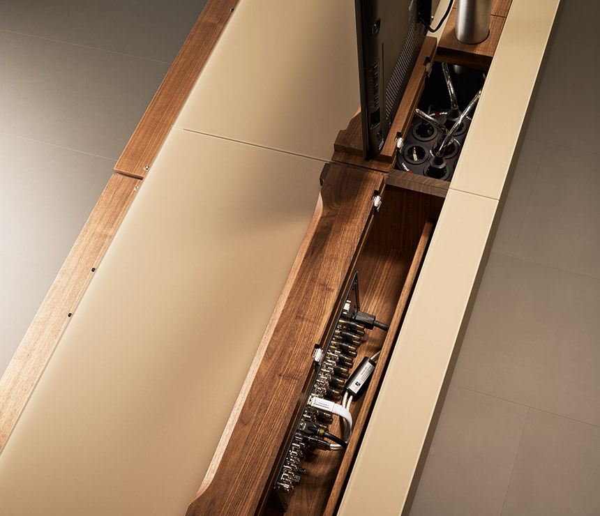Easily-accessible cable tidy run on the high-end TV cabinet in wood and glass