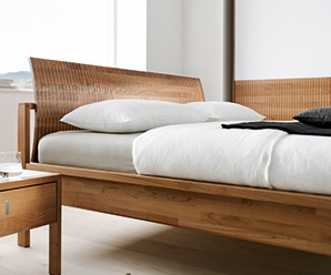 Luxurious modern bed shown in solid walnut wood