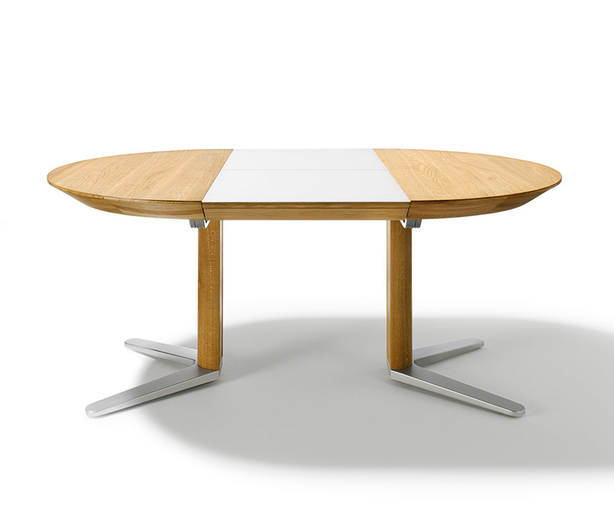 The Girado round dining table shown extended