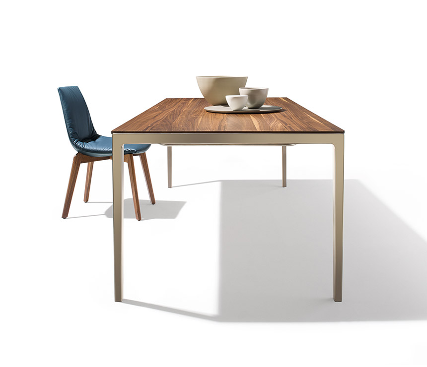 Super slim extendable dining table shown in walnut