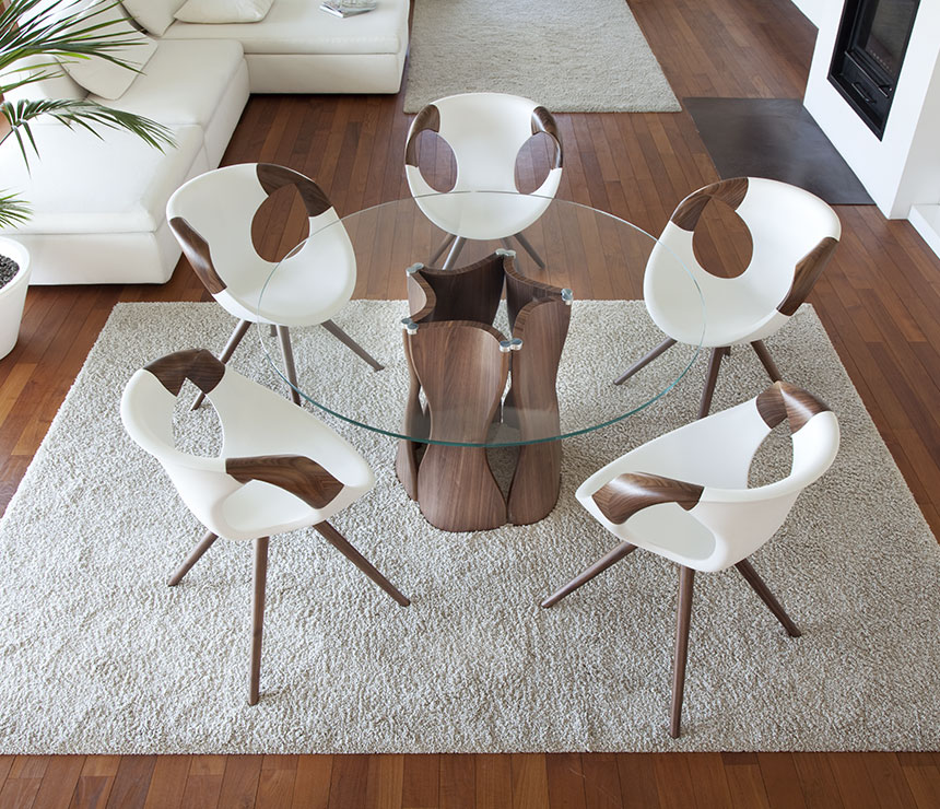 The round version of The 217 glass dining table shown with walnut pedestal base