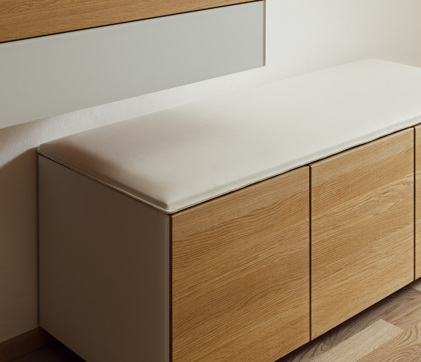 White leather-upholstered hallway storage bench
