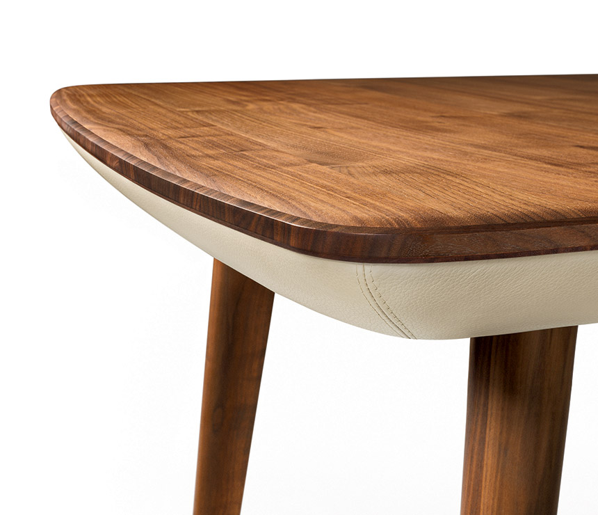 Corner detail of the Flaye wood and leather dining table